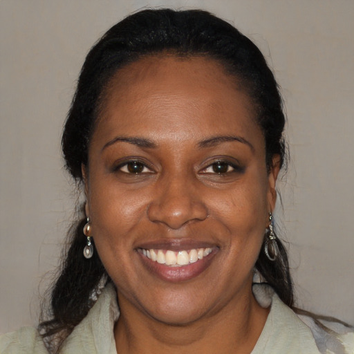 Joyful black young-adult female with medium  brown hair and brown eyes