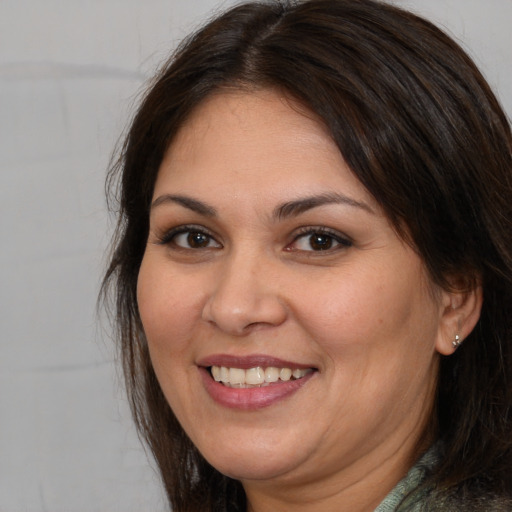 Joyful white adult female with medium  brown hair and brown eyes