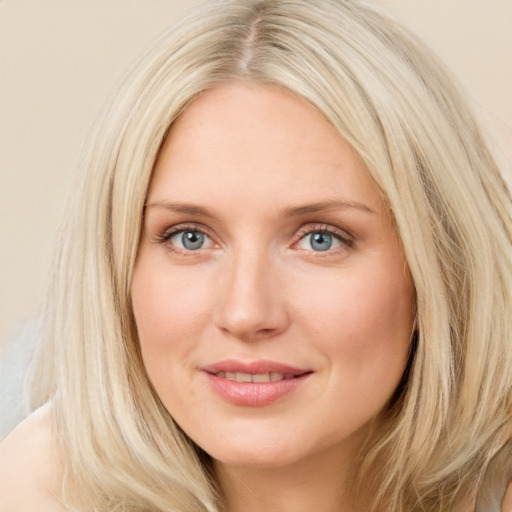 Joyful white young-adult female with long  brown hair and blue eyes