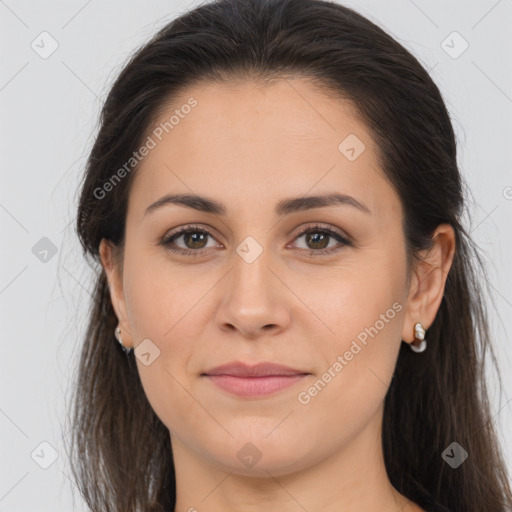 Joyful white young-adult female with long  brown hair and brown eyes