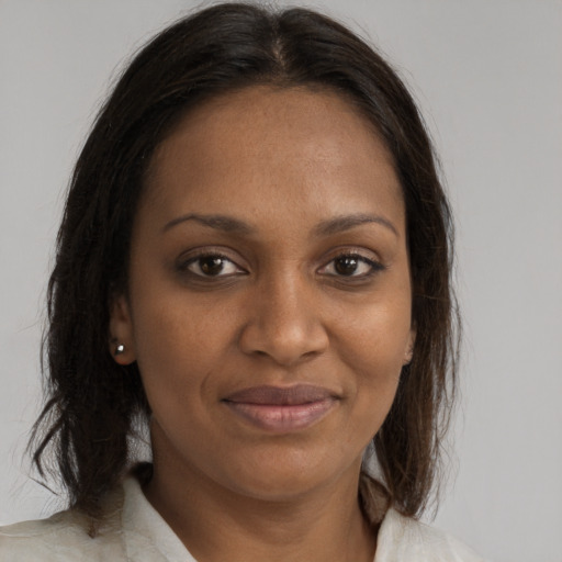 Joyful black young-adult female with medium  brown hair and brown eyes