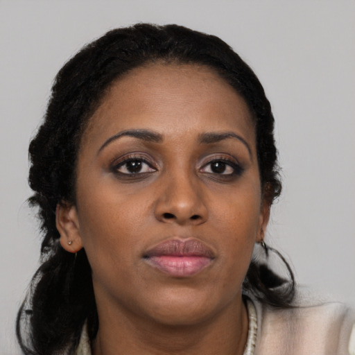 Neutral black young-adult female with long  brown hair and brown eyes