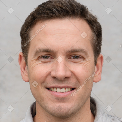 Joyful white adult male with short  brown hair and grey eyes