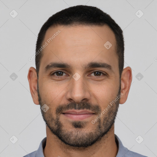 Joyful latino young-adult male with short  black hair and brown eyes