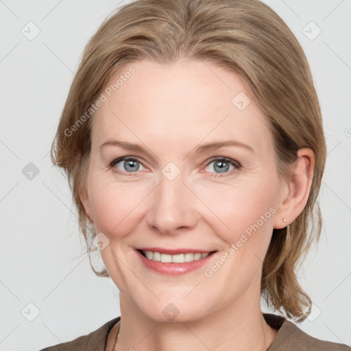 Joyful white adult female with medium  brown hair and grey eyes