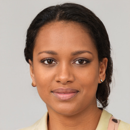 Joyful black young-adult female with short  brown hair and brown eyes
