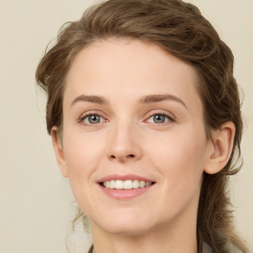 Joyful white young-adult female with long  brown hair and green eyes