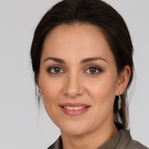 Joyful white young-adult female with medium  brown hair and brown eyes
