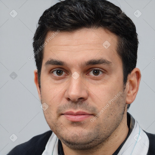 Joyful white young-adult male with short  black hair and brown eyes