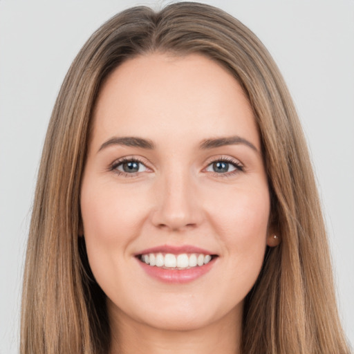 Joyful white young-adult female with long  brown hair and brown eyes