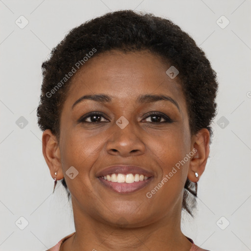 Joyful black young-adult female with short  brown hair and brown eyes