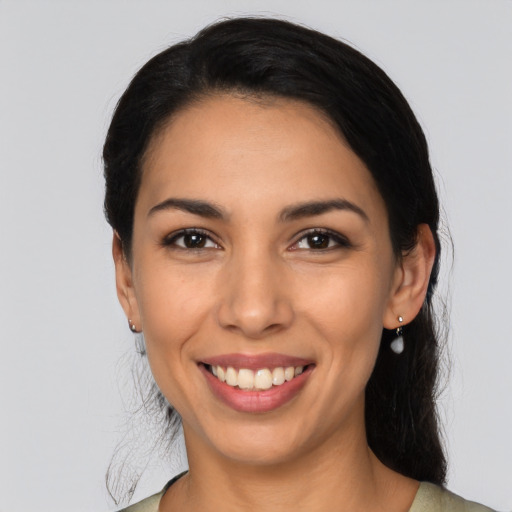 Joyful latino young-adult female with long  black hair and brown eyes