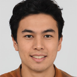 Joyful asian young-adult male with short  brown hair and brown eyes