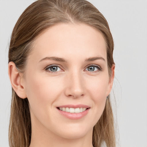 Joyful white young-adult female with long  brown hair and blue eyes