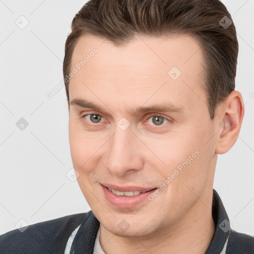 Joyful white young-adult male with short  brown hair and brown eyes