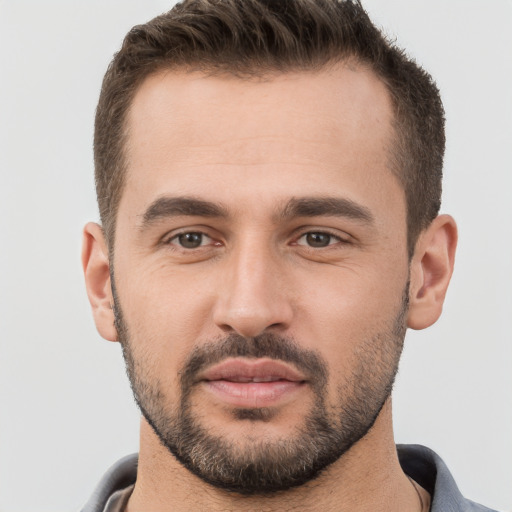 Joyful white young-adult male with short  brown hair and brown eyes