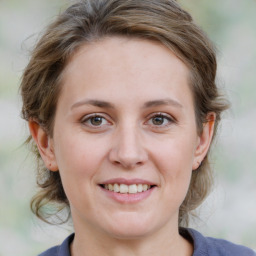 Joyful white young-adult female with medium  brown hair and grey eyes