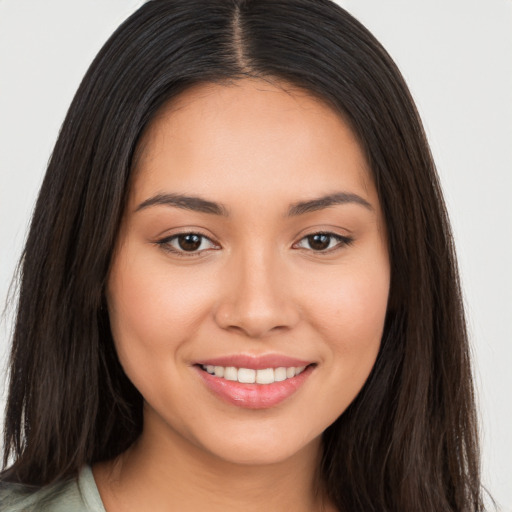 Joyful white young-adult female with long  brown hair and brown eyes