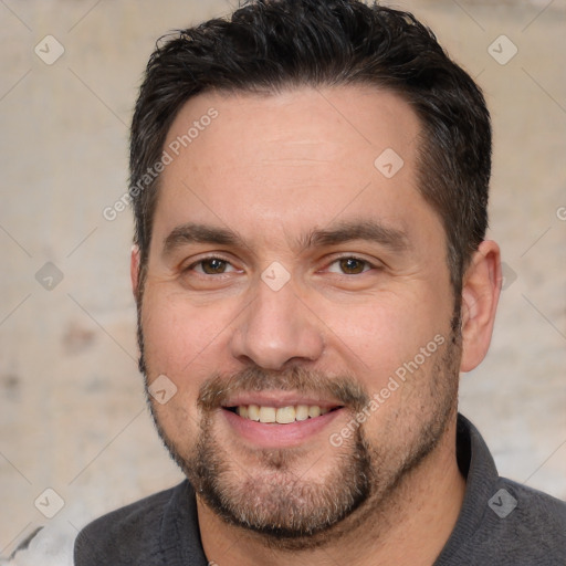 Joyful white adult male with short  brown hair and brown eyes