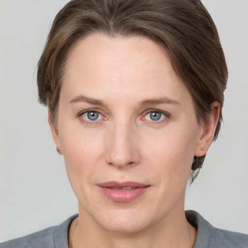 Joyful white adult female with medium  brown hair and grey eyes