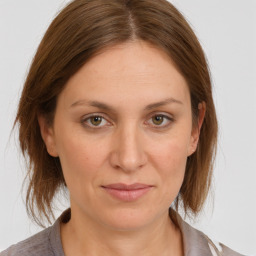 Joyful white young-adult female with medium  brown hair and grey eyes