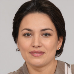 Joyful white adult female with medium  brown hair and brown eyes