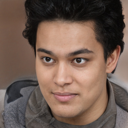 Joyful latino young-adult male with short  brown hair and brown eyes