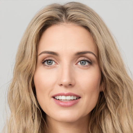 Joyful white young-adult female with long  brown hair and green eyes