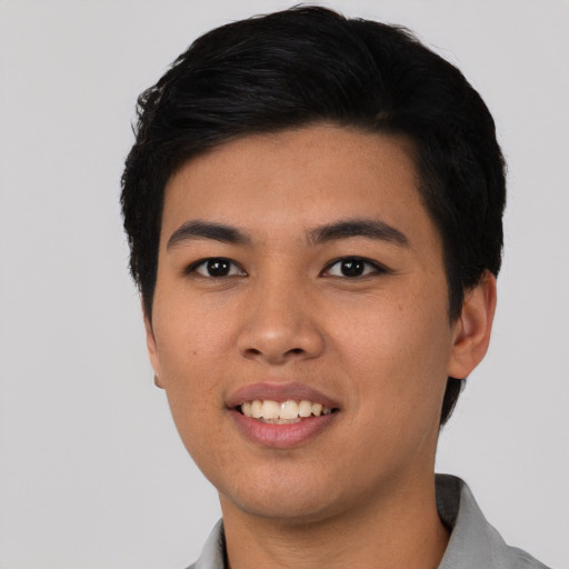 Joyful asian young-adult male with short  black hair and brown eyes