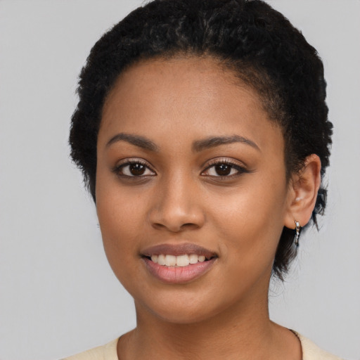 Joyful latino young-adult female with short  black hair and brown eyes