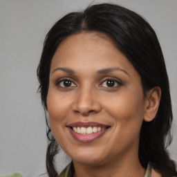 Joyful black adult female with medium  brown hair and brown eyes