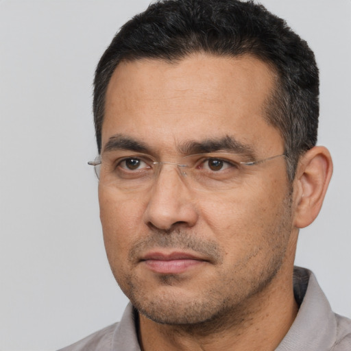 Joyful white adult male with short  black hair and brown eyes