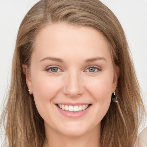 Joyful white young-adult female with long  brown hair and grey eyes