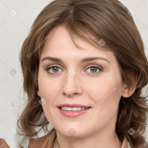 Joyful white young-adult female with medium  brown hair and blue eyes