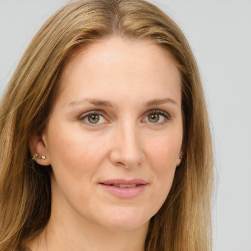 Joyful white young-adult female with long  brown hair and green eyes