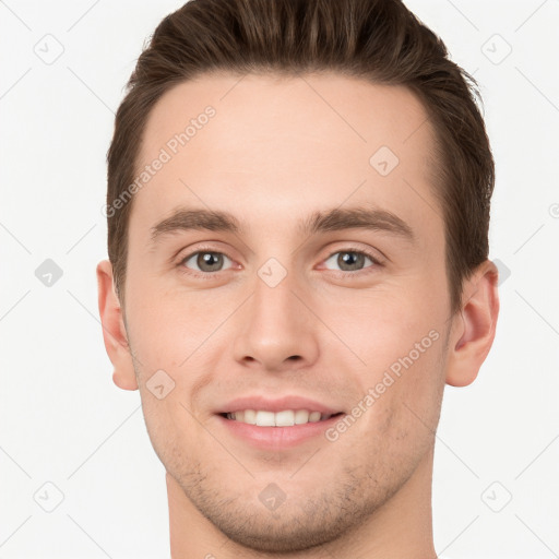 Joyful white young-adult male with short  brown hair and grey eyes