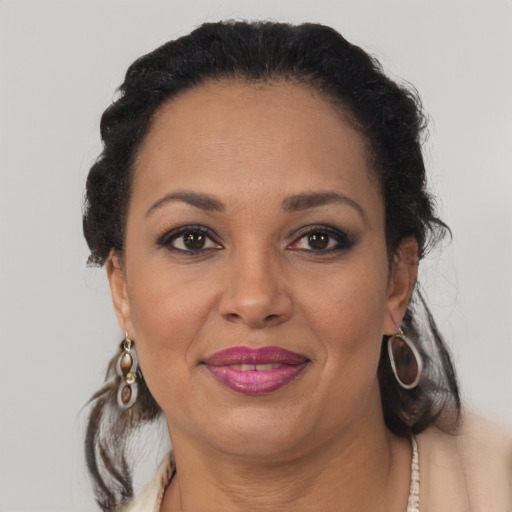 Joyful black adult female with medium  brown hair and brown eyes