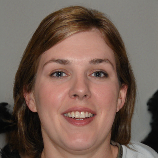 Joyful white young-adult female with medium  brown hair and blue eyes