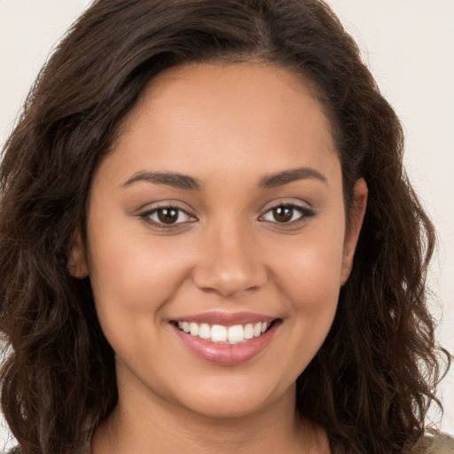 Joyful white young-adult female with long  brown hair and brown eyes