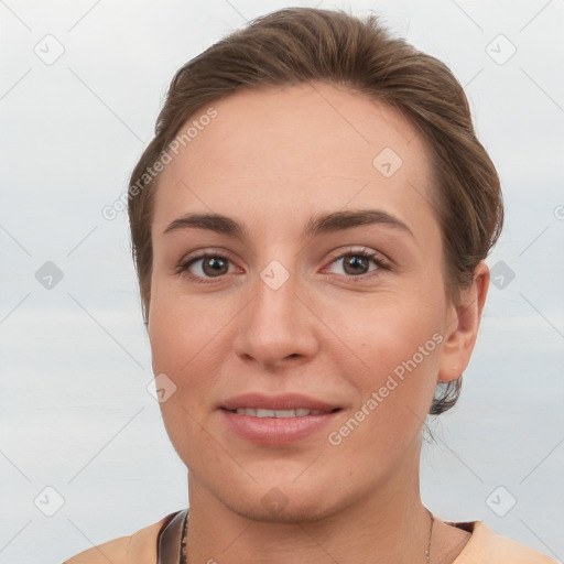 Joyful white young-adult female with short  brown hair and grey eyes