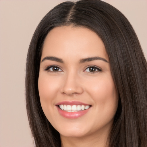 Joyful white young-adult female with long  black hair and brown eyes