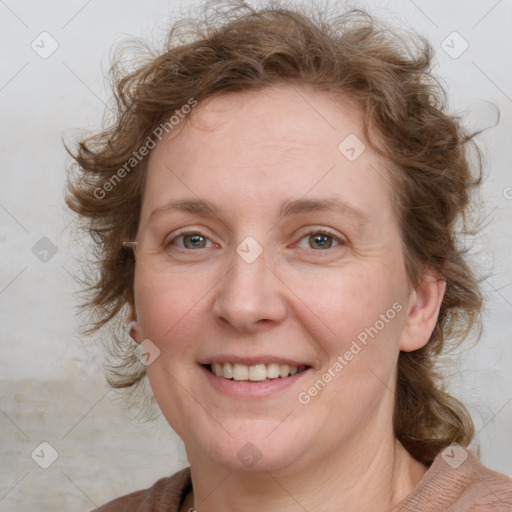 Joyful white adult female with medium  brown hair and blue eyes