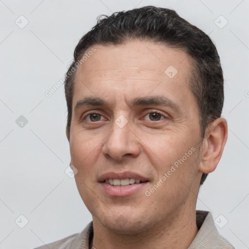 Joyful white adult male with short  brown hair and brown eyes