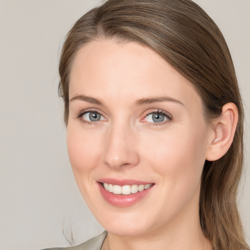 Joyful white young-adult female with long  brown hair and blue eyes