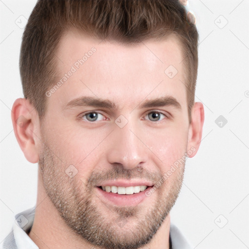 Joyful white young-adult male with short  brown hair and grey eyes