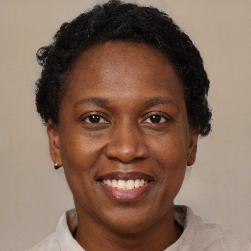 Joyful black adult female with short  brown hair and brown eyes