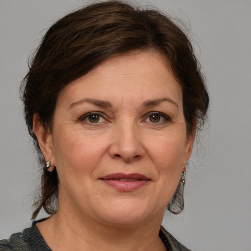 Joyful white adult female with medium  brown hair and grey eyes