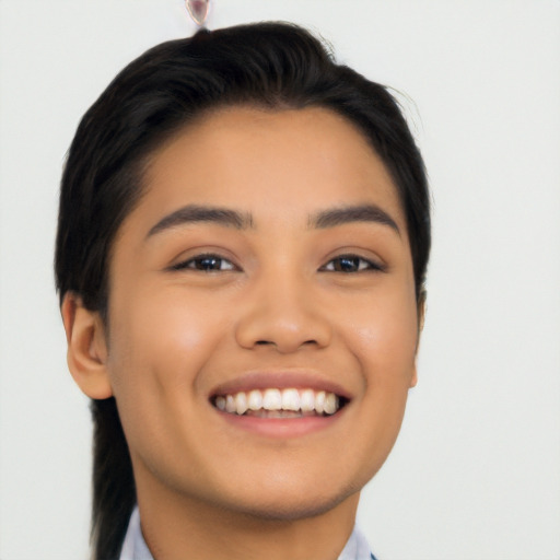 Joyful latino young-adult female with short  black hair and brown eyes