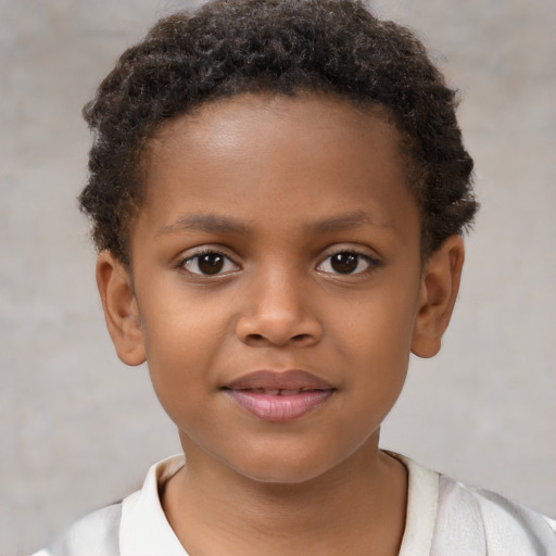 Joyful black child male with short  brown hair and brown eyes