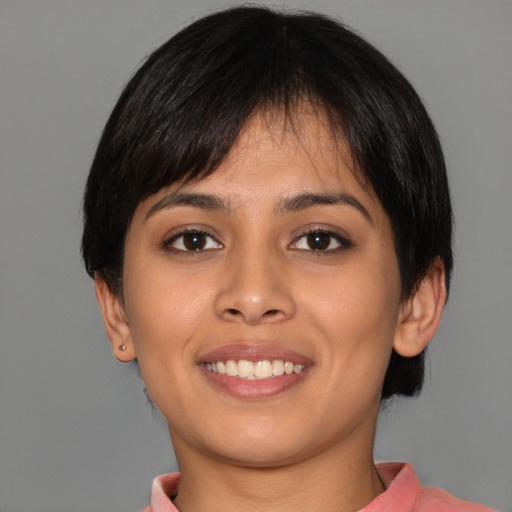 Joyful white young-adult female with short  black hair and brown eyes
